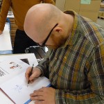 Yoann signing Spirou 54 TL, photo (ill. Yoann & Vehlmann; (c) Dupuis and the artists; image from dupuis.com)